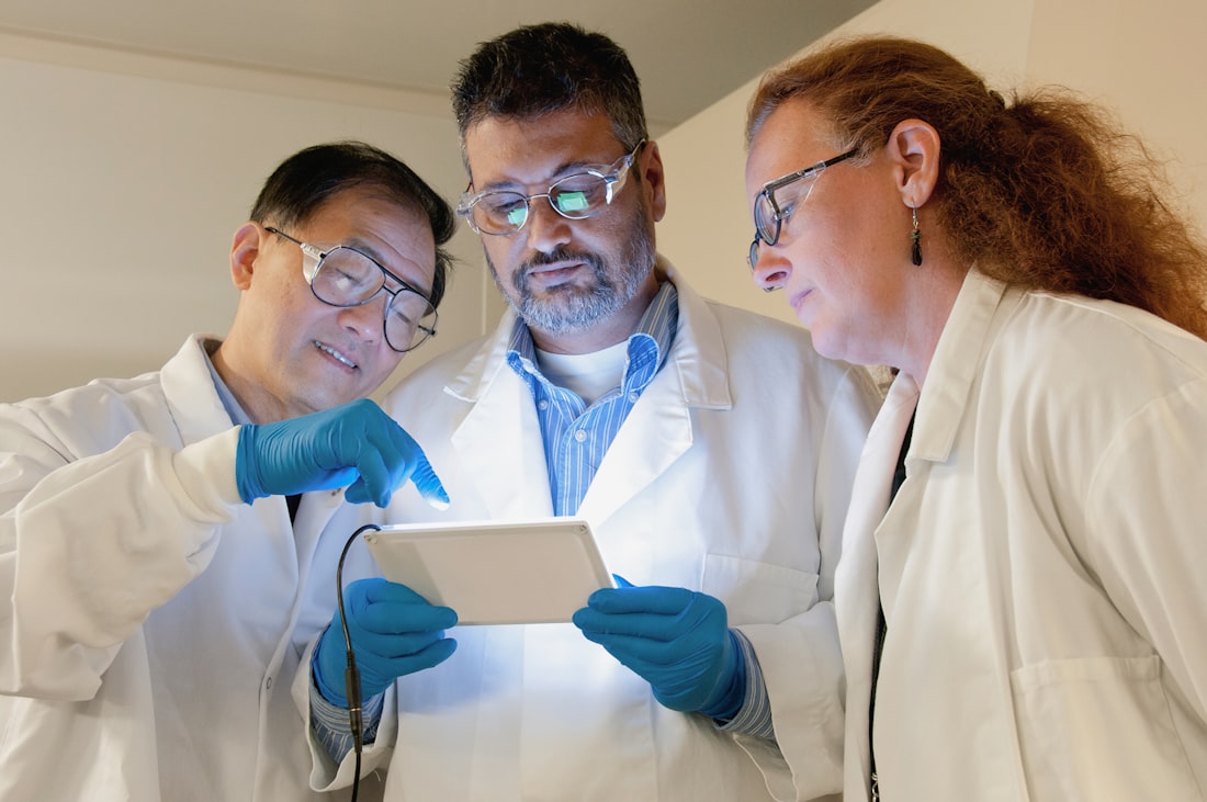 A molecular pathology team reviewing results at Consultative Genomics